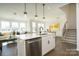 Modern kitchen features white cabinetry, stainless steel appliances, and an island at 5919 Wetlands Aly, Charlotte, NC 28215
