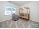 bedroom with crib, glider, and window at 5919 Wetlands Aly, Charlotte, NC 28215