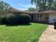 Ranch style home with mature landscaping and a large yard at 9408 Sandburg Ave, Charlotte, NC 28213
