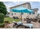 Relaxing brick patio with lounge chairs, umbrella, fire pit, and spacious backyard at 634 Carson Rd, Gastonia, NC 28052