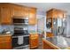 Kitchen boasts stainless steel appliances and wood cabinets at 634 Carson Rd, Gastonia, NC 28052