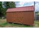 Wooden storage shed with double doors and a window at 634 Carson Rd, Gastonia, NC 28052