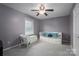 Cozy bedroom with daybed, window seating and ceiling fan at 634 Carson Rd, Gastonia, NC 28052