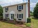 Two story house, beige siding, black shutters, brick steps at 634 Carson Rd, Gastonia, NC 28052