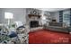 Living room featuring a fireplace, comfy seating, and red carpet at 634 Carson Rd, Gastonia, NC 28052