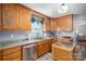 Kitchen with wood cabinets, stainless steel appliances, and an island at 634 Carson Rd, Gastonia, NC 28052