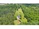 Aerial view of house on wooded lot with detached structure at 909 Shinnville Rd, Mooresville, NC 28115