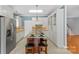 Modern kitchen with island, white cabinets, and stainless steel appliances at 909 Shinnville Rd, Mooresville, NC 28115