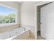 Bathroom with a large jetted tub and linen closet at 909 Shinnville Rd, Mooresville, NC 28115