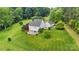 Aerial view of a house with large backyard and surrounding trees at 909 Shinnville Rd, Mooresville, NC 28115