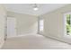 Spacious bedroom with carpet and two windows at 909 Shinnville Rd, Mooresville, NC 28115