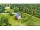 Aerial view of house, yard, and surrounding trees at 909 Shinnville Rd, Mooresville, NC 28115