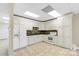 Basement kitchen features white cabinets, granite counters, and tile floors at 909 Shinnville Rd, Mooresville, NC 28115
