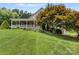 Ranch style home with front porch and manicured lawn at 909 Shinnville Rd, Mooresville, NC 28115