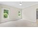 Well-lit bedroom with carpet flooring and large windows at 909 Shinnville Rd, Mooresville, NC 28115