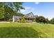 Brick house with a covered porch, landscaping and a large yard at 909 Shinnville Rd, Mooresville, NC 28115