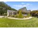 Brick ranch house with a covered porch and landscaped yard at 909 Shinnville Rd, Mooresville, NC 28115