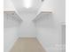 Large walk-in closet with built-in shelving and hanging rods at 909 Shinnville Rd, Mooresville, NC 28115