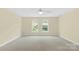 Spacious bedroom featuring two arched windows and carpeted floors at 909 Shinnville Rd, Mooresville, NC 28115