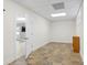 Finished basement room with tile flooring and access to other rooms at 909 Shinnville Rd, Mooresville, NC 28115