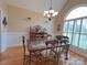 Bright dining room features a large window, chandelier, and hardwood floors at 115 Anson Dr, China Grove, NC 28023