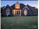 Brick home with a welcoming front porch at night at 115 Anson Dr, China Grove, NC 28023