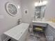 Bathroom with modern freestanding tub and gray vanity at 115 Anson Dr, China Grove, NC 28023