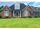Brick home with landscaped yard and large windows at 115 Anson Dr, China Grove, NC 28023