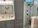 Modern bathroom with gray cabinets, double vanity, and walk-in shower at 115 Anson Dr, China Grove, NC 28023