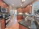 Modern kitchen with granite countertops, wood cabinets and stainless steel appliances at 115 Anson Dr, China Grove, NC 28023