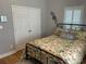 Bedroom with floral bedding, wood floors, and window shutters at 115 Anson Dr, China Grove, NC 28023