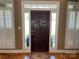 Elegant entryway with hardwood floors, a rich wood door and white shutters at 115 Anson Dr, China Grove, NC 28023