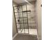 Modern bathroom featuring a sleek glass shower enclosure and gray tile at 7378 Winery Ln, Charlotte, NC 28227