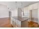 Large kitchen island with granite countertop and hardwood floors at 101 Mcalway Rd, Charlotte, NC 28211