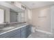 Modern bathroom with gray double vanity and marble tile at 101 Mcalway Rd, Charlotte, NC 28211