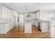 Modern kitchen with white cabinets, granite island, and hardwood floors at 101 Mcalway Rd, Charlotte, NC 28211