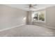 Bright bedroom featuring a large window and ceiling fan at 101 Mcalway Rd, Charlotte, NC 28211