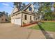 Three-car garage with white doors and a brick exterior at 101 Mcalway Rd, Charlotte, NC 28211