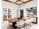 Bright dining room features a wood table, modern chandelier, and wine storage at 108 Sail High Ct, Mooresville, NC 28117