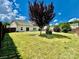 Large backyard with fenced area, grass, and tree at 422 Bougainvillea Ct, Monroe, NC 28110