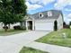 House exterior showcasing a white garage door and landscaping at 422 Bougainvillea Ct, Monroe, NC 28110
