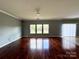 Open concept living area with hardwood floors and backyard view at 422 Bougainvillea Ct, Monroe, NC 28110