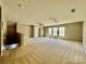 Large bonus room featuring wall-to-wall carpet and multiple windows at 422 Bougainvillea Ct, Monroe, NC 28110