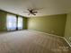 Bright and airy carpeted bedroom with ceiling fan and window at 422 Bougainvillea Ct, Monroe, NC 28110
