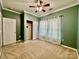 Bedroom with green walls, ceiling fan, and window at 422 Bougainvillea Ct, Monroe, NC 28110