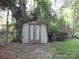 Small wooden shed in backyard, surrounded by trees at 237 W 3Rd St, Kershaw, SC 29067