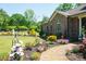 Landscaped yard with brick walkway, lush greenery, and flowers at 4642 King Crowder Dr, Gastonia, NC 28052