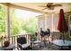 Relaxing back porch with ceiling fan, comfortable seating, and a grill at 4642 King Crowder Dr, Gastonia, NC 28052