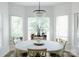 Spacious dining area featuring a round table and chandelier, bathed in natural light at 4642 King Crowder Dr, Gastonia, NC 28052