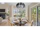 Charming dining area with a table for four, adjacent to the kitchen and backyard views at 4023 Randolph Rd, Charlotte, NC 28211
